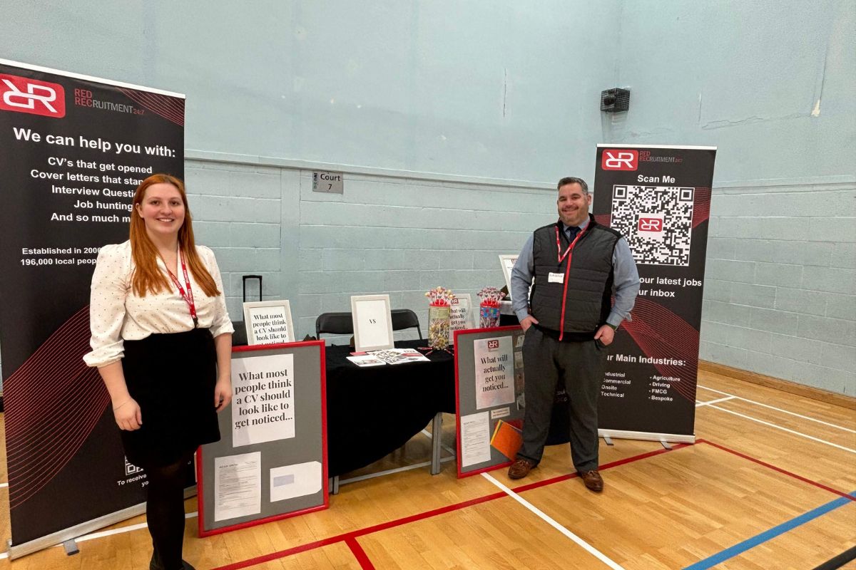 Red Recruitment 24:7 team speaking with job seekers at a local jobs fair